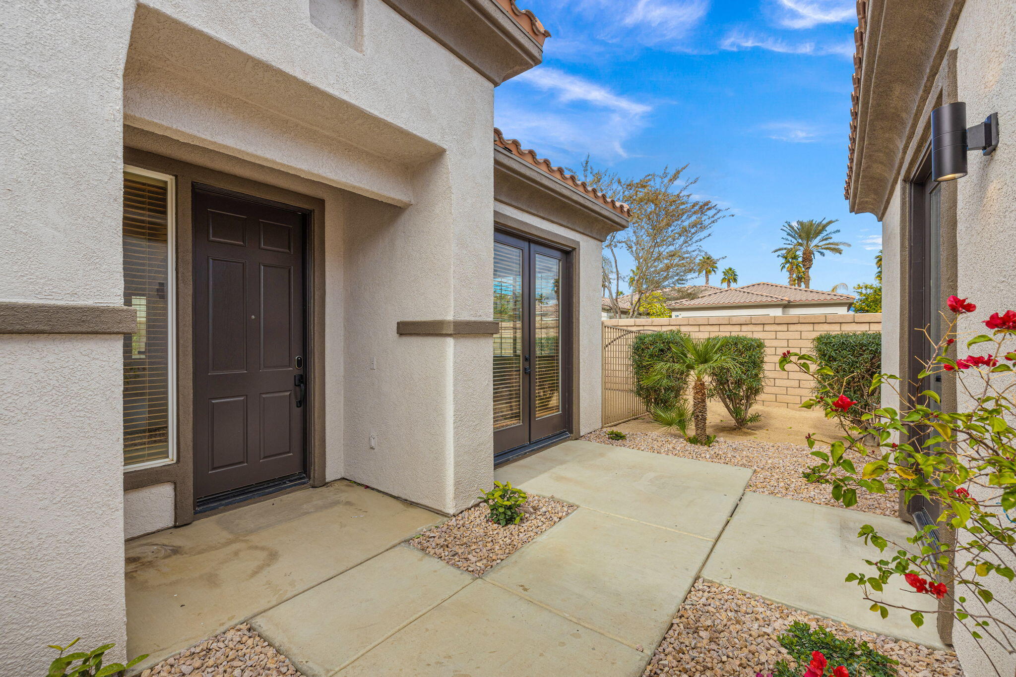 48537 Via Estacio Indio, CA 92201 - Photo 13 of 57 a view of a porch with a table and chairs and potted plants