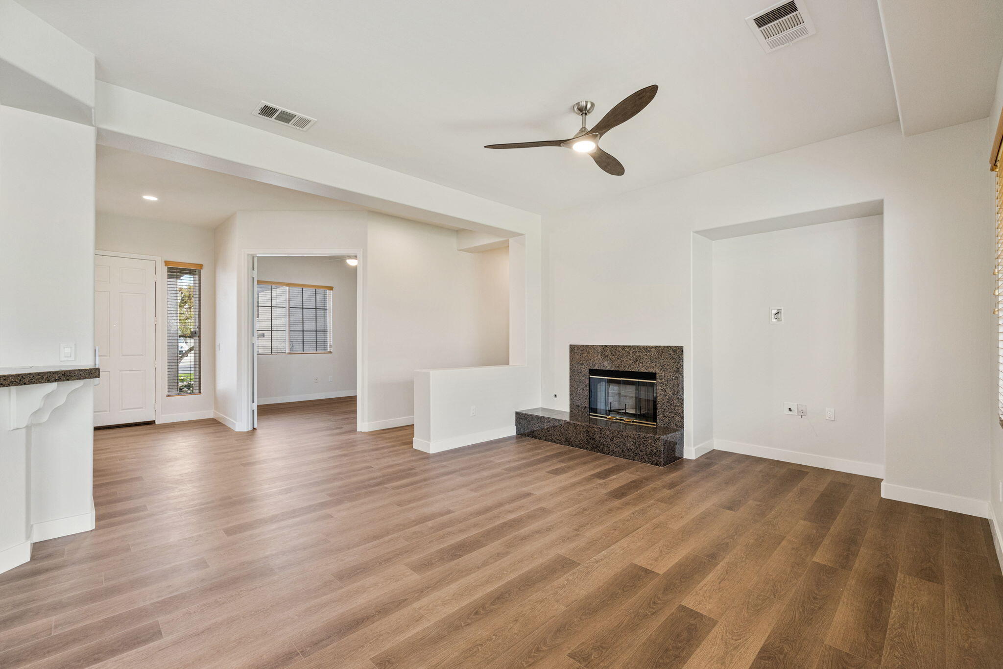 48537 Via Estacio Indio, CA 92201 - Photo 3 of 57 an empty room with wooden floor fireplace and windows