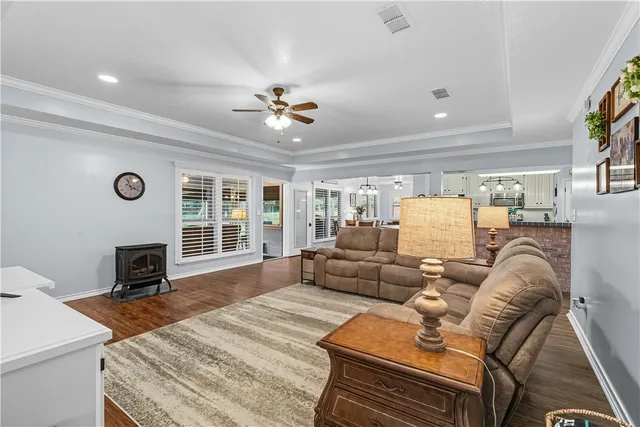 a living room with patio furniture and a floor to ceiling window