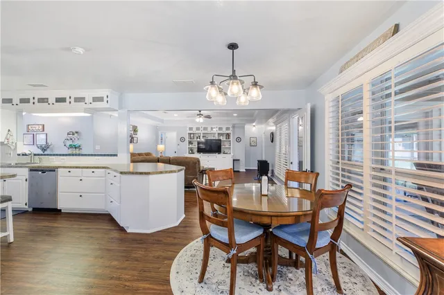 a view of a backyard with a garden and tree