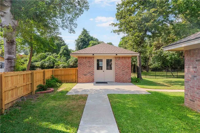a view of a dining room with furniture a chandelier and wooden floor