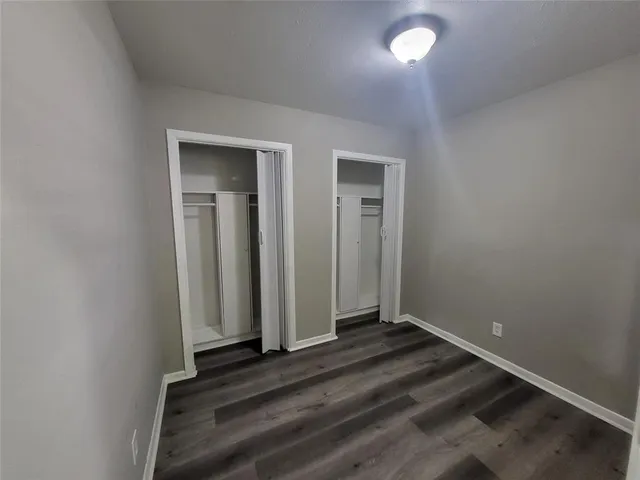 a view of hallway with wooden floor