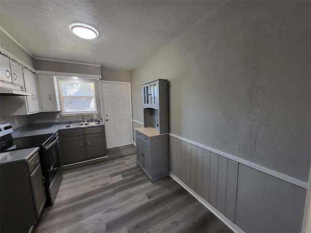 a room with wooden floor and white walls