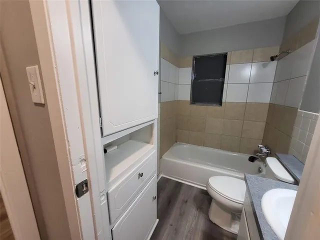 a bathroom with a sink toilet and mirror