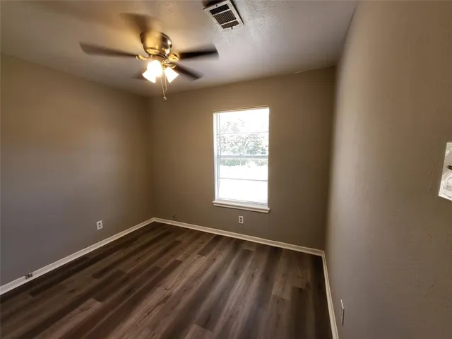 a view of an empty room with a fan