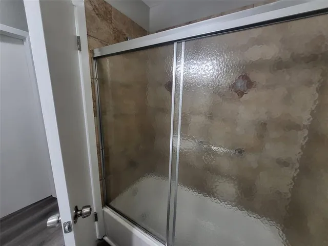 a bathroom with a glass shower door