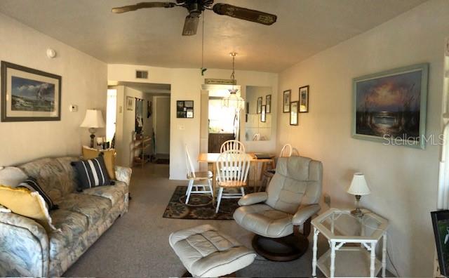 16881 Davis Road, Unit 723 Fort Myers, FL 33908 - Photo 12 of 13 a living room with furniture and a flat screen tv