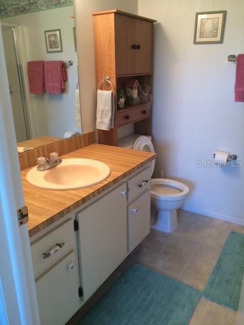 16881 Davis Road, Unit 723 Fort Myers, FL 33908 - Photo 2 of 13 a bathroom with a granite countertop sink and a mirror