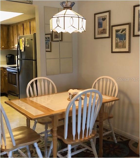 16881 Davis Road, Unit 723 Fort Myers, FL 33908 - Photo 6 of 13 a dining room with furniture and window