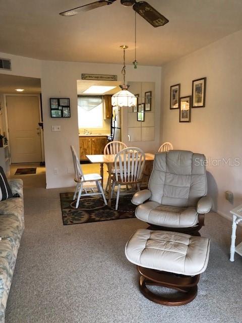16881 Davis Road, Unit 723 Fort Myers, FL 33908 - Photo 8 of 13 a living room with furniture and a chandelier