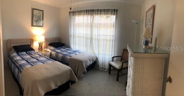 16881 Davis Road, Unit 723 Fort Myers, FL 33908 - Photo 10 of 13 a bedroom with two beds and a window