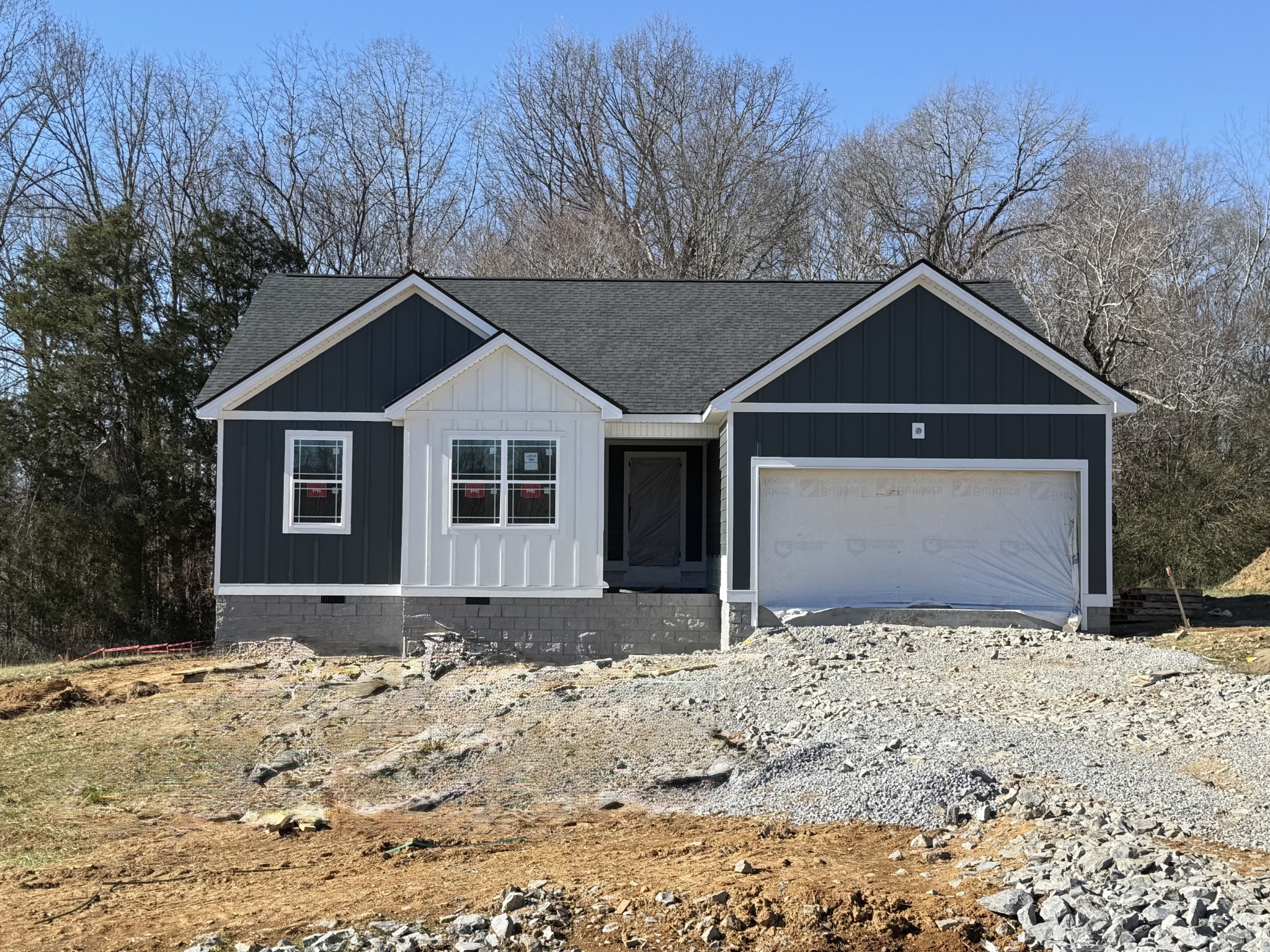 504 Mandalorian Way Dickson, TN 37055 - Photo 2 of 3 a front view of a house with a yard covered in snow