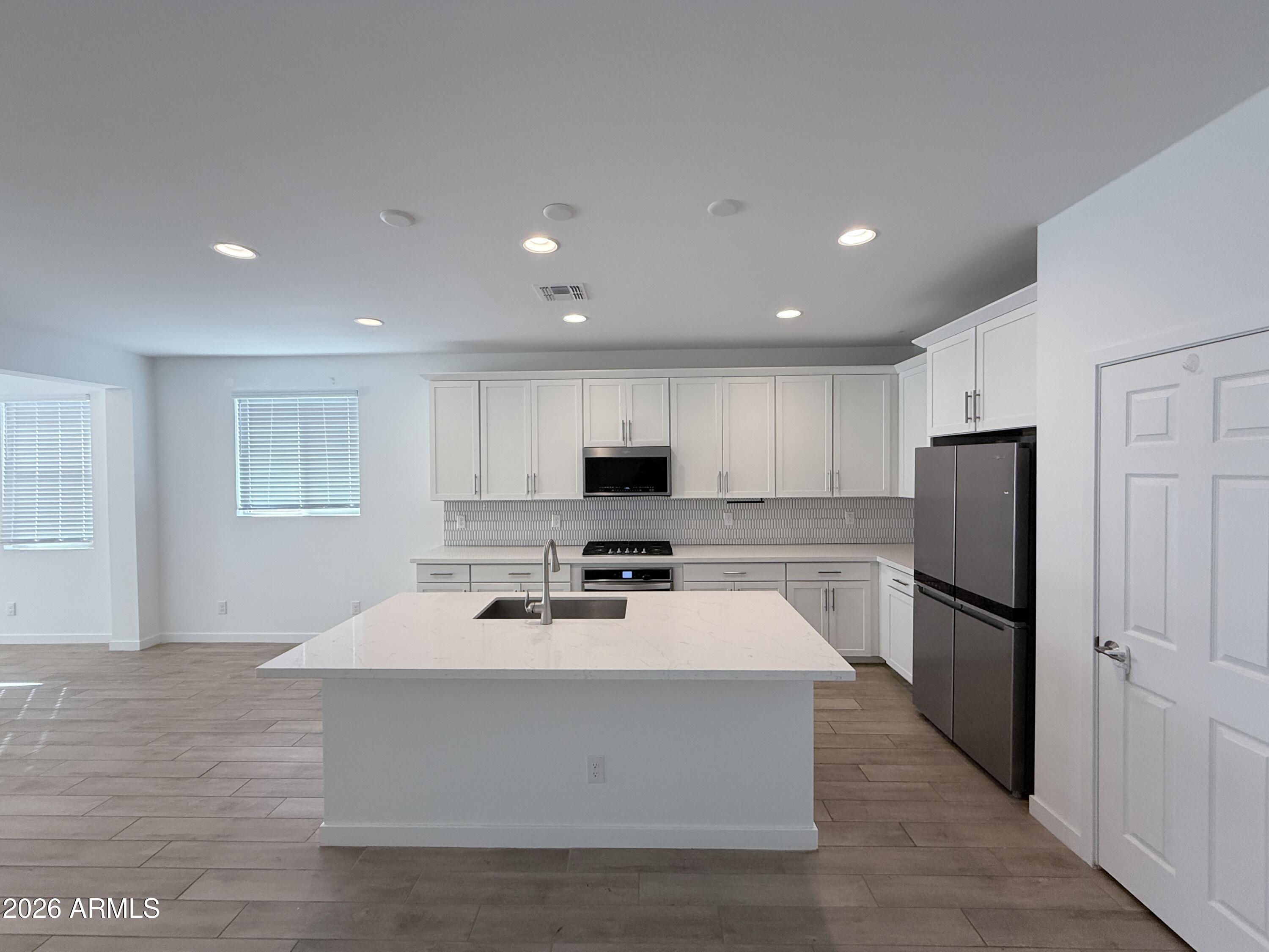 4323 West Palace Sta Road New River, AZ 85087 - Photo 6 of 20 a kitchen with stainless steel appliances a refrigerator sink and microwave