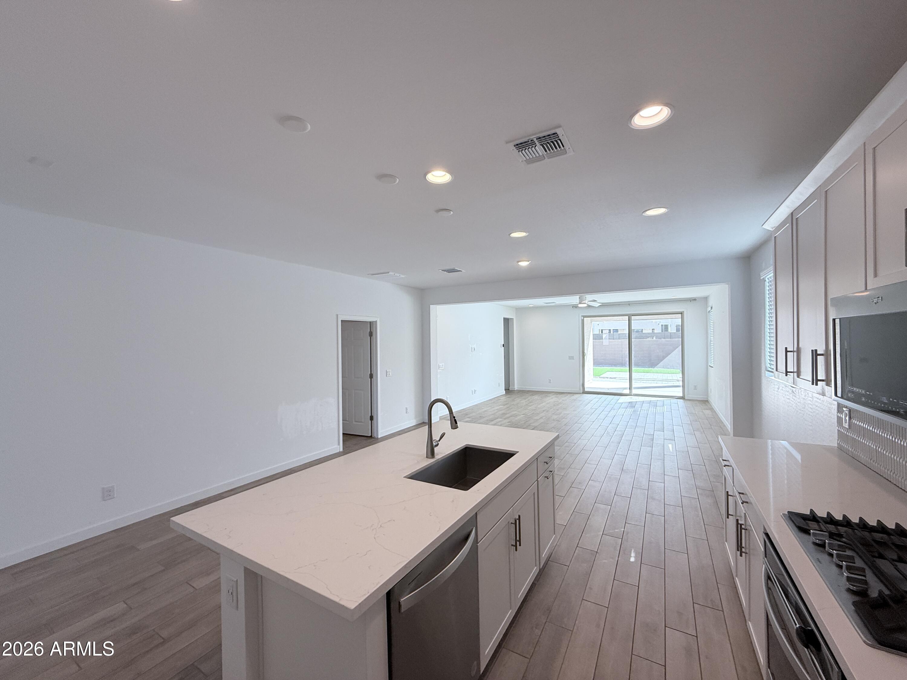4323 West Palace Sta Road New River, AZ 85087 - Photo 7 of 20 a kitchen that has a sink and a stove in it