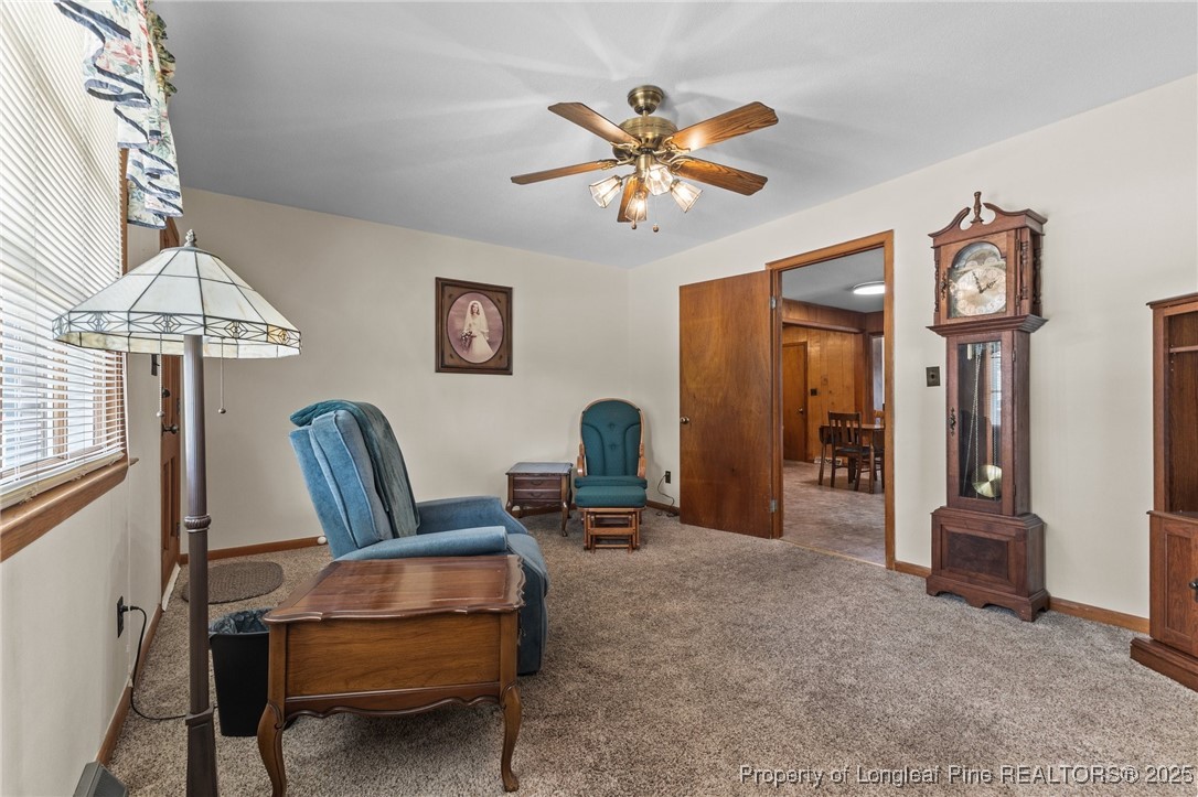 209 4th Street Erwin, NC 28339 - Photo 14 of 43 a living room with furniture a chandelier and a window