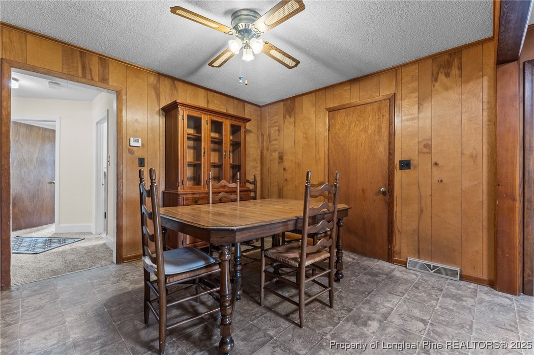 209 4th Street Erwin, NC 28339 - Photo 16 of 43 a view of a dining room with furniture and chandelier fan