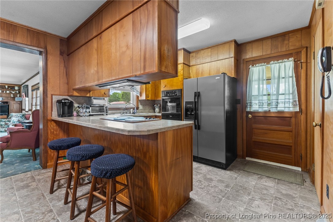 209 4th Street Erwin, NC 28339 - Photo 19 of 43 a kitchen with stainless steel appliances granite countertop a refrigerator a stove and a sink with cabinets