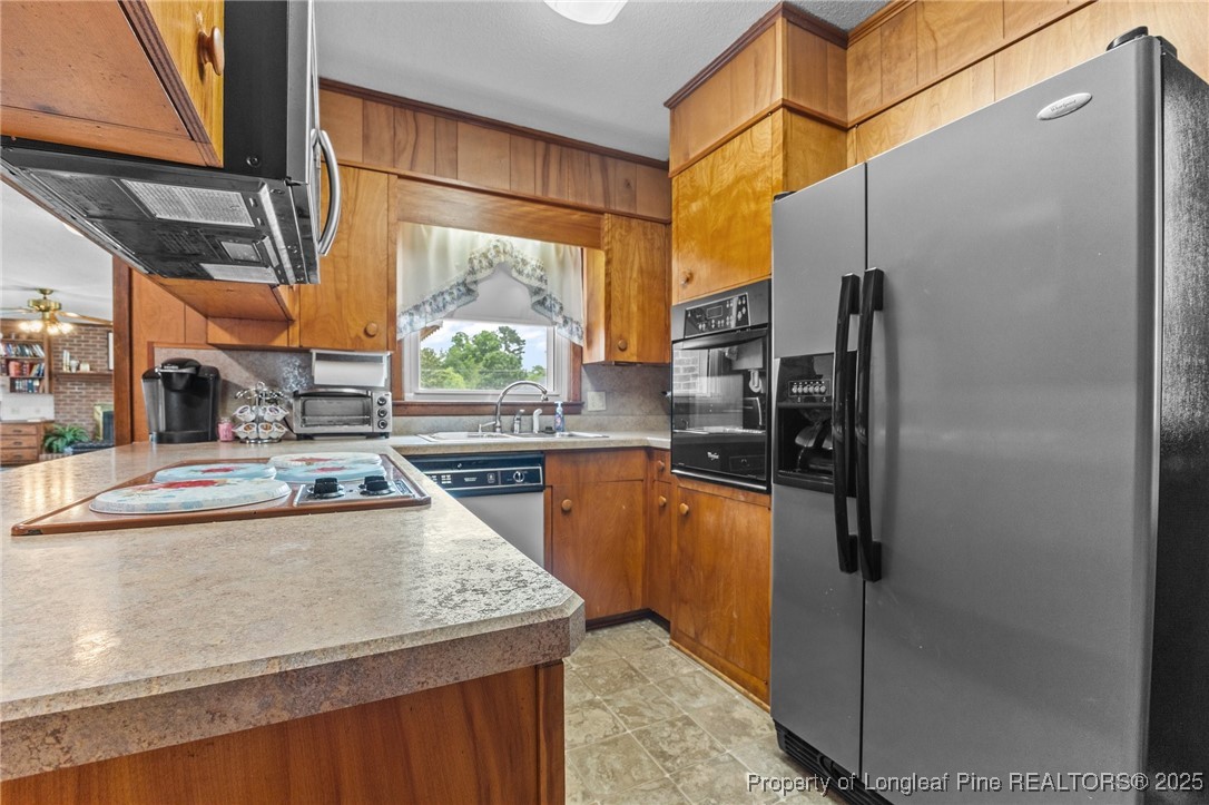 209 4th Street Erwin, NC 28339 - Photo 20 of 43 a kitchen with stainless steel appliances granite countertop a refrigerator a oven and a sink