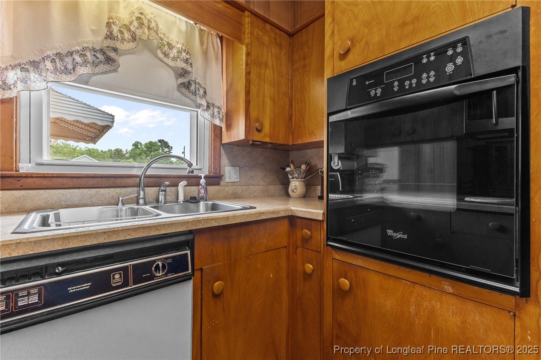 209 4th Street Erwin, NC 28339 - Photo 22 of 43 a kitchen with a sink and a stove