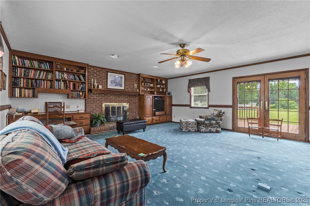 209 4th Street Erwin, NC 28339 - Photo 28 of 43 a living room with furniture a fireplace and a large window