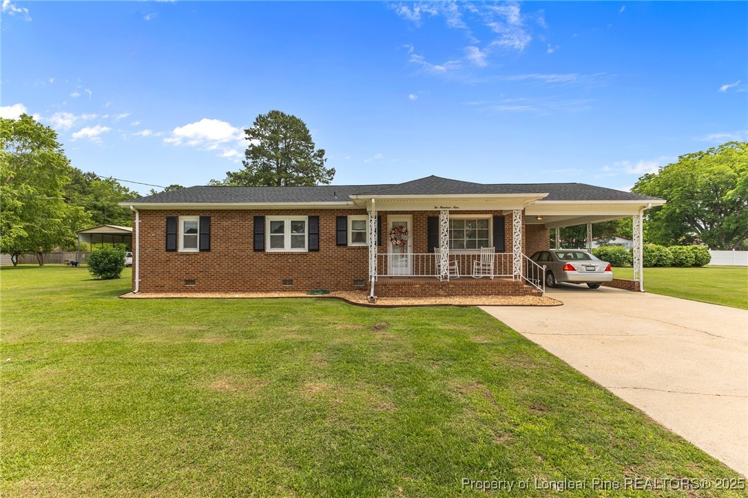 209 4th Street Erwin, NC 28339 - Photo 6 of 43 a view of a house with a backyard porch and sitting area