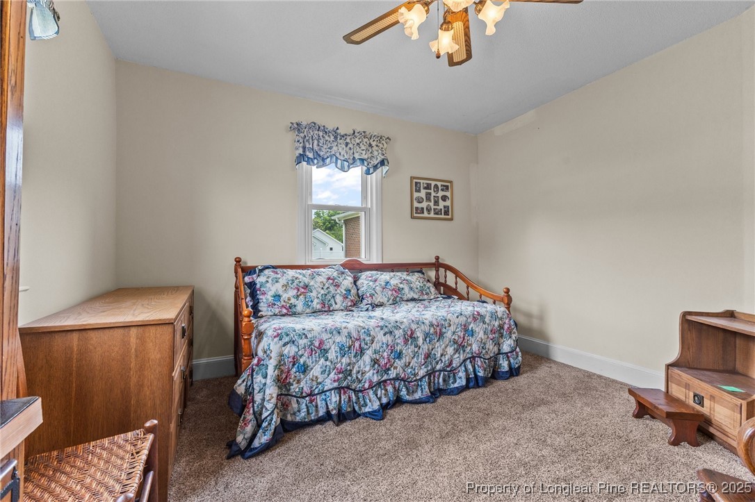209 4th Street Erwin, NC 28339 - Photo 8 of 43 a bedroom with a bed and a couch