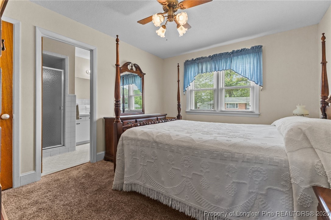 209 4th Street Erwin, NC 28339 - Photo 10 of 43 a spacious bedroom with a bed and a large window