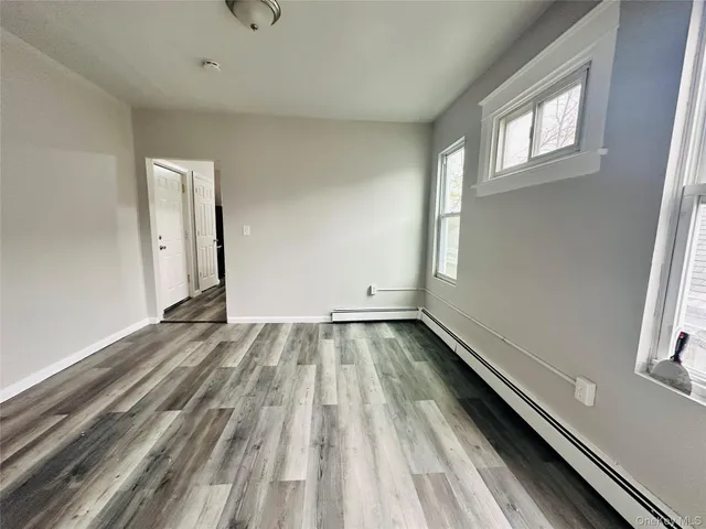 a view of a room with wooden floor