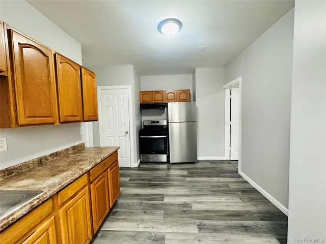 a kitchen with stainless steel appliances granite countertop a refrigerator and a stove top oven