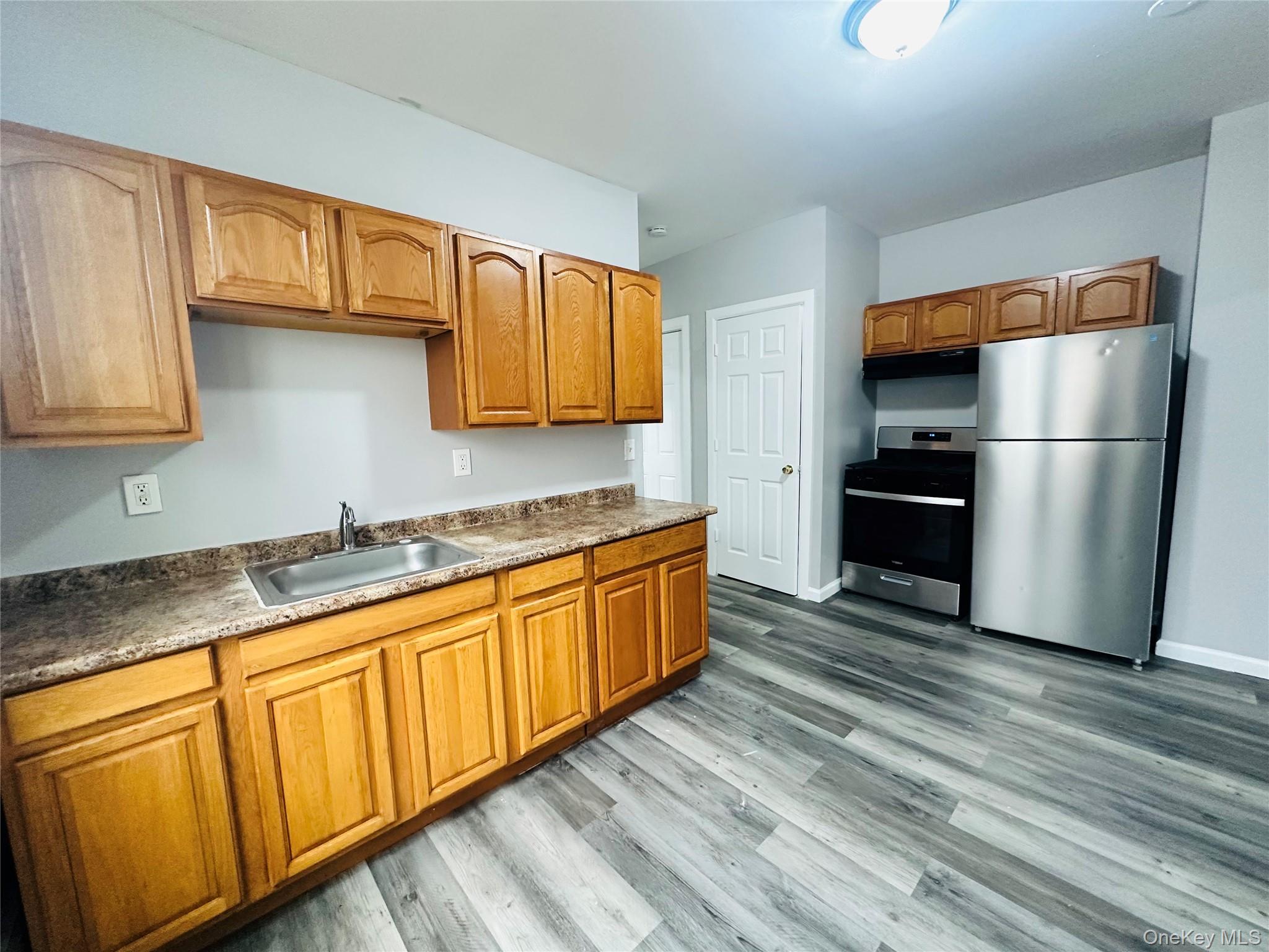 7 Franklin Street, Unit #7 Poughkeepsie, NY 12601 - Photo 6 of 11 a kitchen with stainless steel appliances granite countertop a refrigerator sink and cabinets