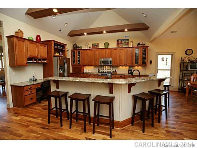 3457 Harmony Road Catawba, SC 29704 - Photo 6 of 24 a kitchen with stainless steel appliances kitchen island granite countertop a table chairs and a refrigerator