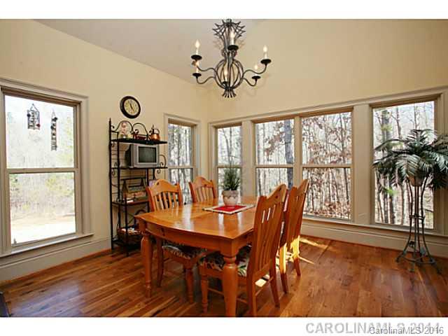 3457 Harmony Road Catawba, SC 29704 - Photo 9 of 24 a dining room with furniture a large window and wooden floor