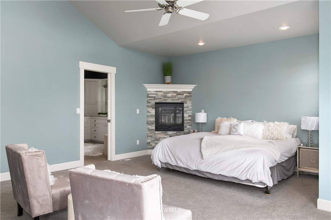 1026 North 27th Place Renton, WA 98056 - Photo 22 of 38 a bedroom with a bed and a fireplace
