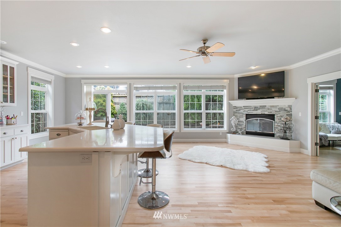 1026 North 27th Place Renton, WA 98056 - Photo 8 of 38 a dining hall with a large window and a fireplace with wooden floor