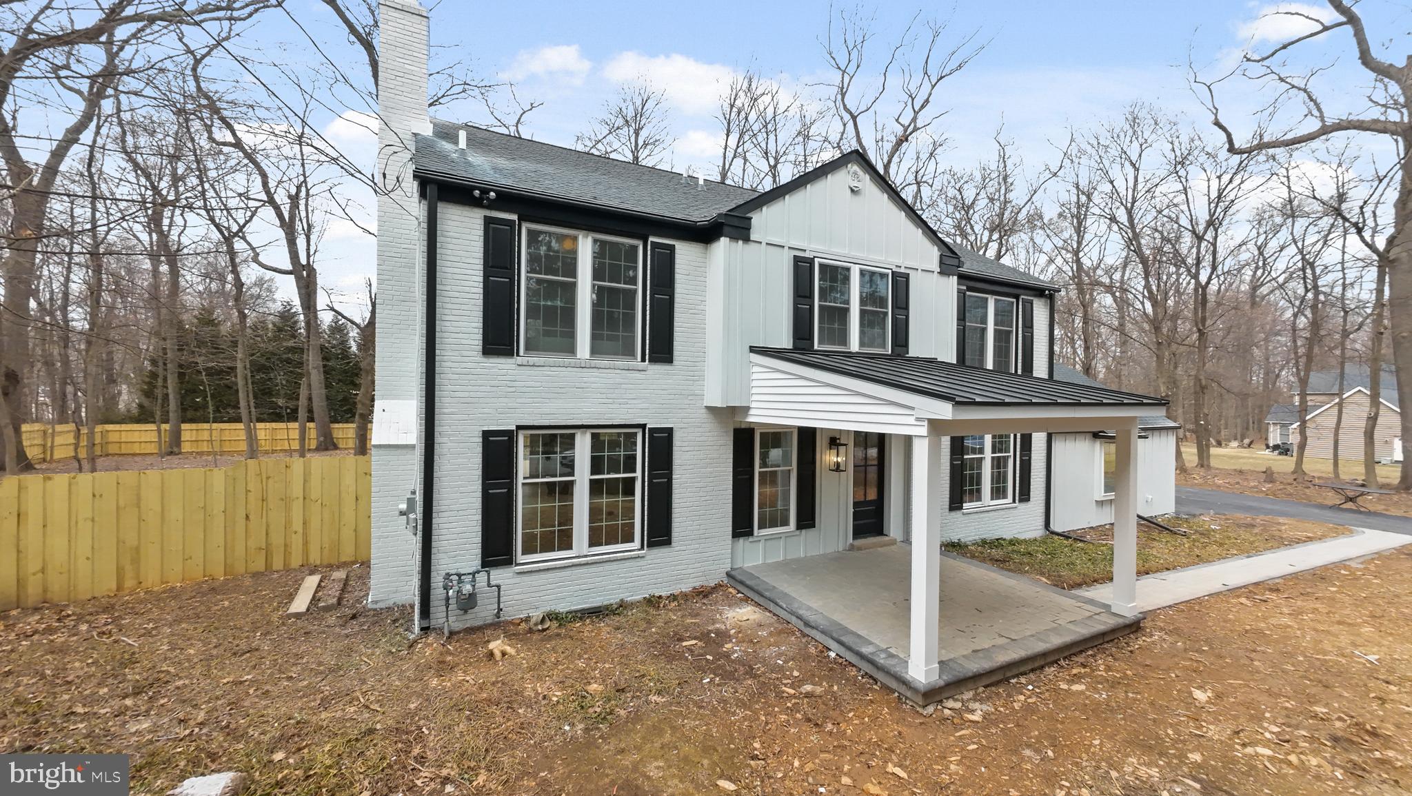 827 Weadley Road Wayne, PA 19087 - Photo 4 of 96 a view of a white house with large windows and a large tree