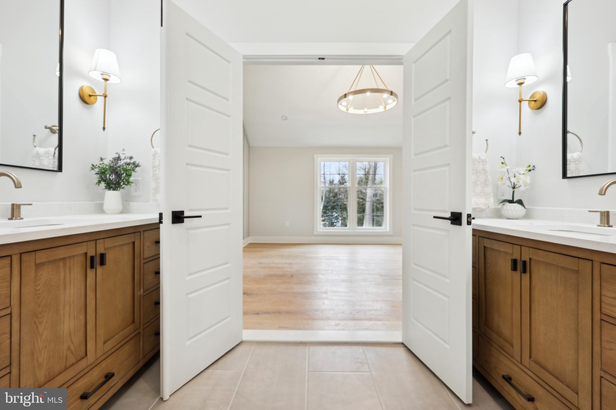 827 Weadley Road Wayne, PA 19087 - Photo 50 of 96 a bathroom with a double vanity sink a mirror and a bathtub