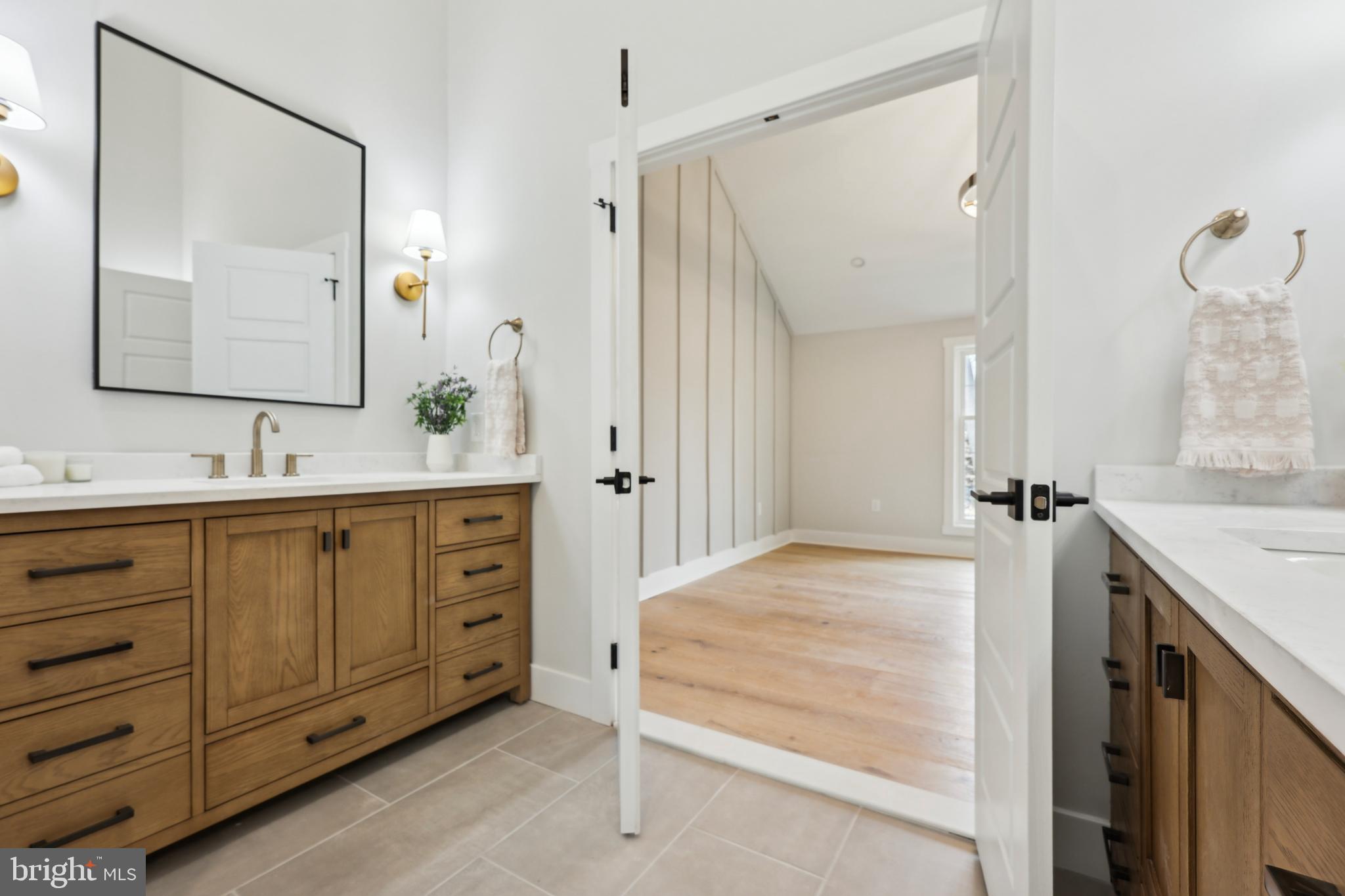 827 Weadley Road Wayne, PA 19087 - Photo 51 of 96 a bathroom with a double vanity sink and mirror