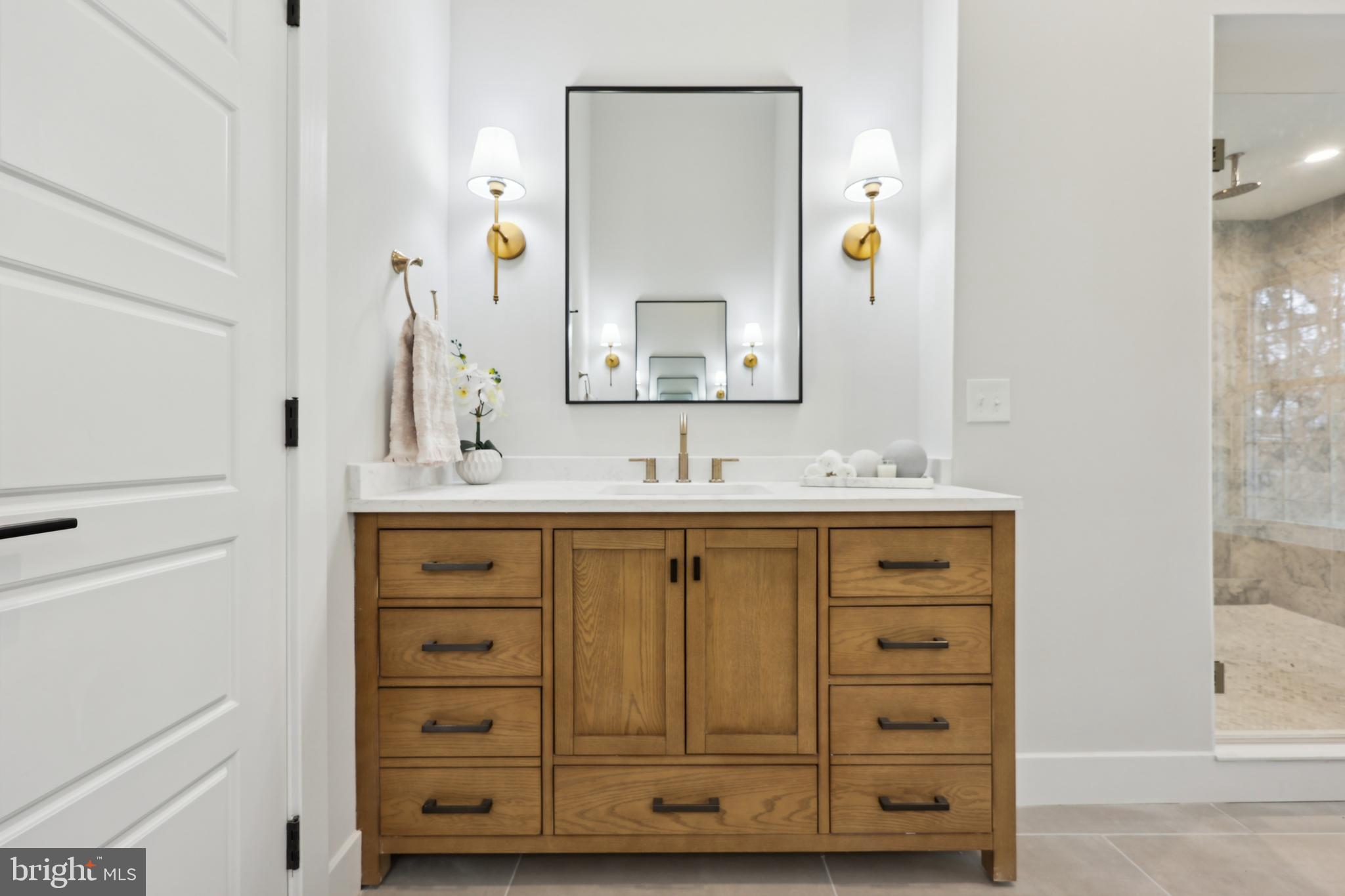 827 Weadley Road Wayne, PA 19087 - Photo 52 of 96 a bathroom with a sink vanity and mirror