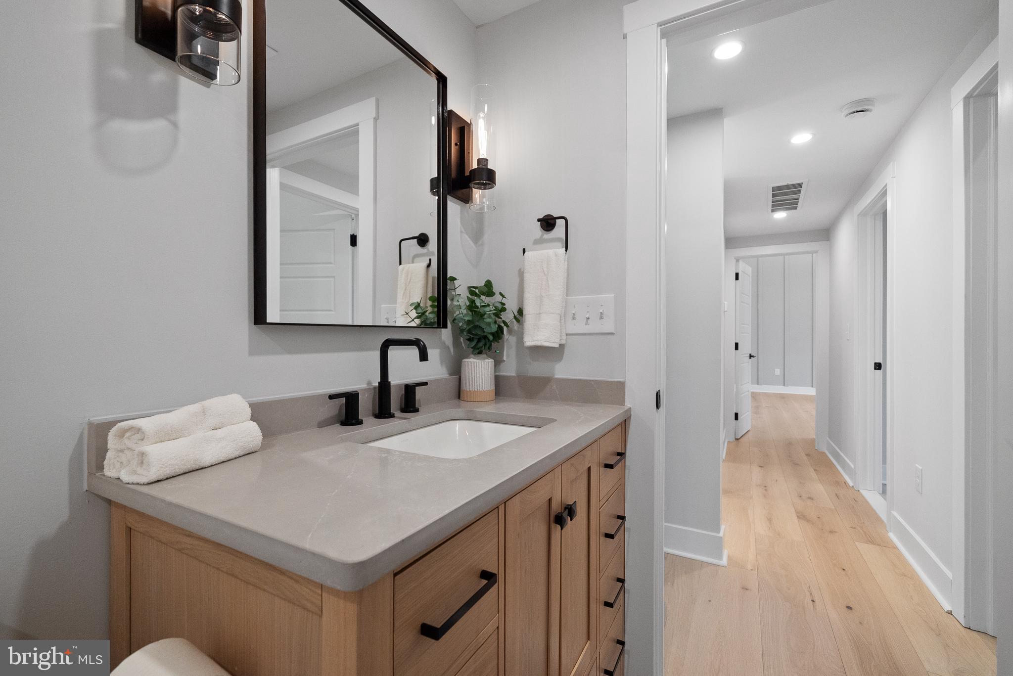 827 Weadley Road Wayne, PA 19087 - Photo 78 of 96 a bathroom with a sink a vanity and a mirror