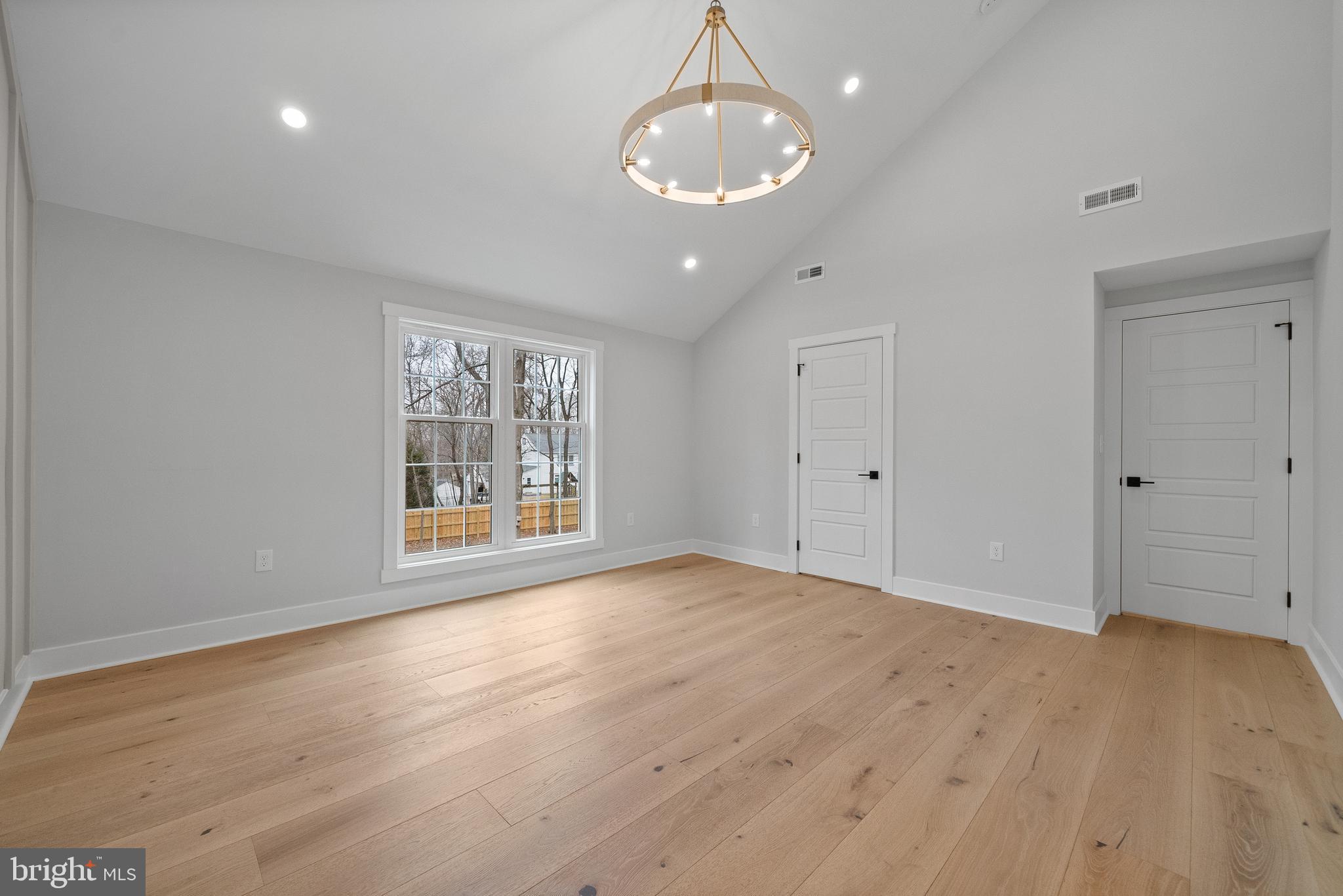 827 Weadley Road Wayne, PA 19087 - Photo 82 of 96 a view of an empty room with wooden floor and a window