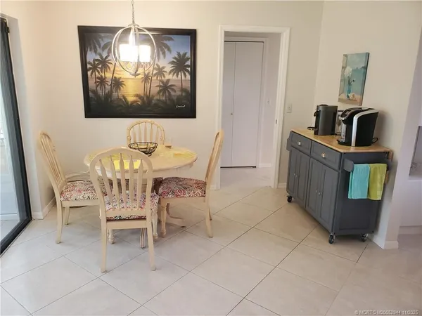 a view of a dining room with furniture and chandelier
