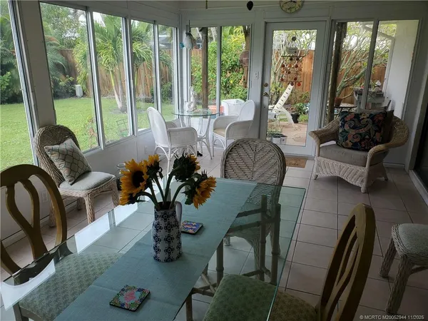 a living room with furniture and floor to ceiling windows