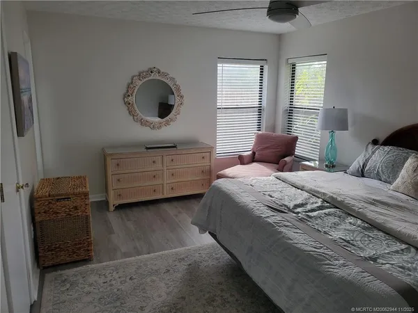 a large bed sitting in a bedroom next to a lamp