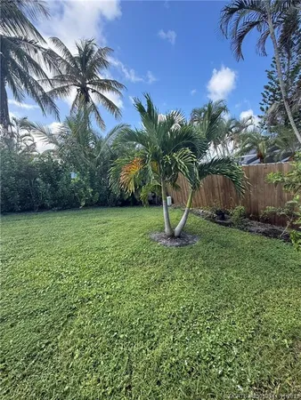 a view of a backyard with plants and a patio
