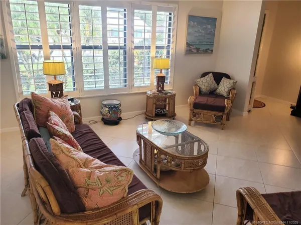 a living room with furniture and a floor to ceiling window