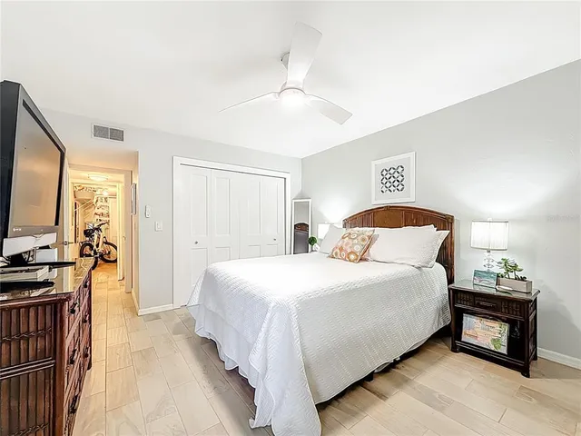 a view of a lake with a table and chairs under an umbrella