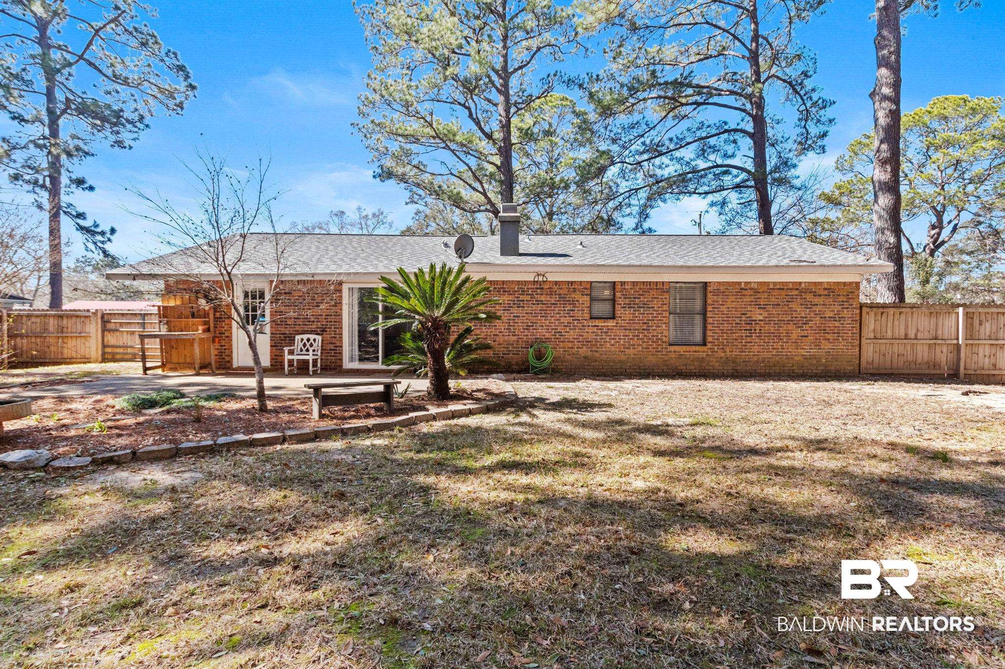 5366 Scanlan Way West Satsuma, AL 36572 - Photo 30 of 43 Rear view of property with a fenced backyard, brick siding, and a patio area