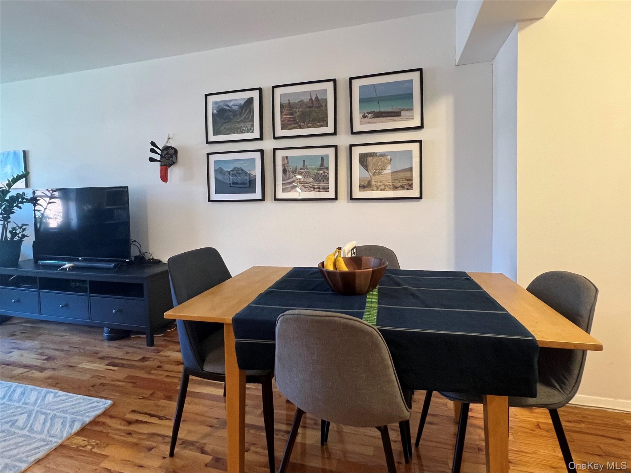 58-03 Calloway Street, Unit 3MM Queens, NY 11368 - Photo 4 of 9 a table and chairs in a living room