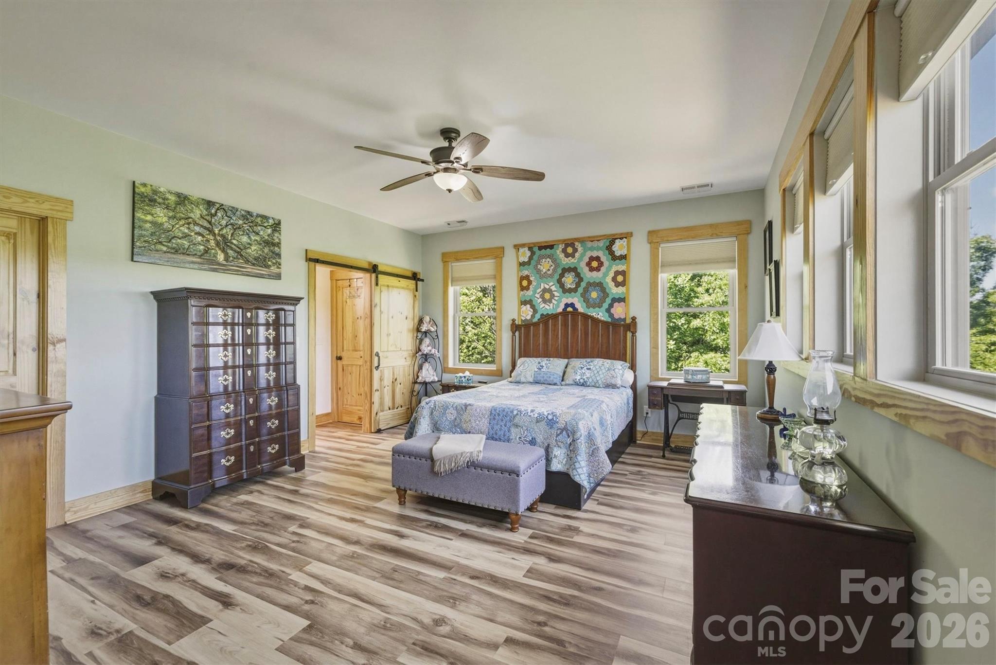 5564 Table View Lane Lenoir, NC 28645 - Photo 19 of 48 a spacious bedroom with a large bed a chandelier and windows
