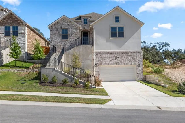 a front view of a house with a garden and plants